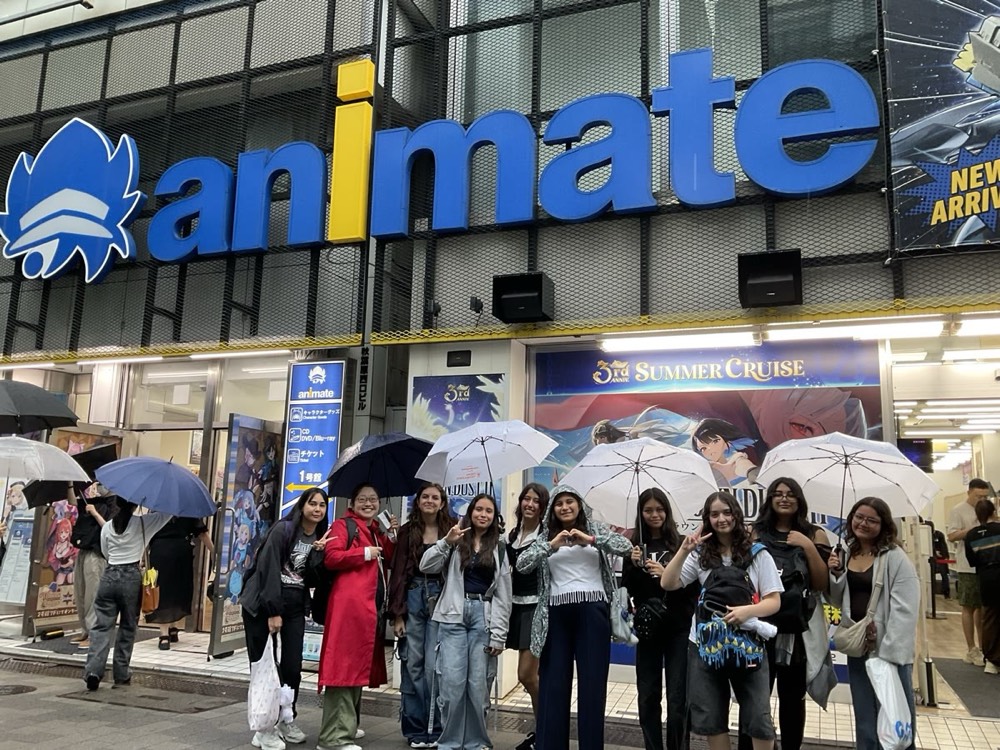 A tour group outside the Animate store in Akihabara, one of the shops that stocks fan art and badges